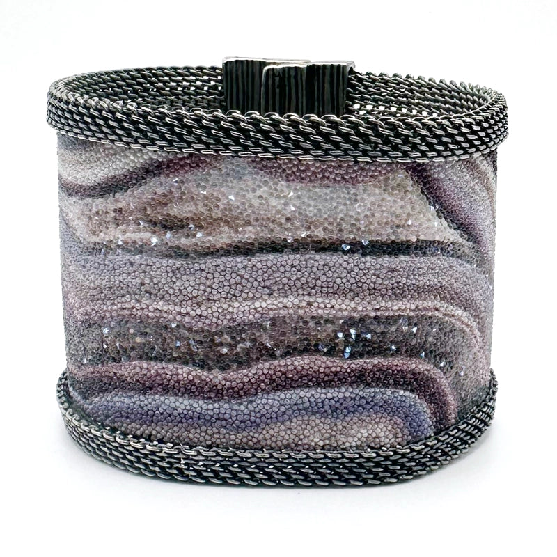 Wide cuff bracelet with oxidized silver mesh framing a multi-color Botswana agate slice pattern highlighted by shiny and matte Swarovski micro-crystals, tilted to show the closed magnetic clasp, on a white background.