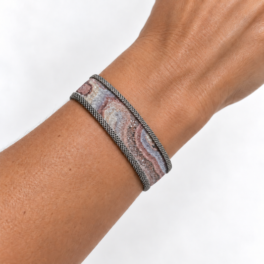 Narrow Botswana agate slab cuff worn on a wrist.