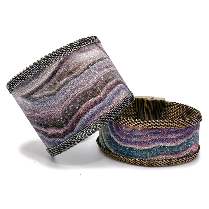 Two Agate Slice Inspired Cuffs - One Wide, One Narrow - with Shimmery and Sparkly Swarovsky Crystals and Brass Mesh Edges, Closed with the Signature Magnetic Clasp, One Leaning On The Other To Show Difference in Width