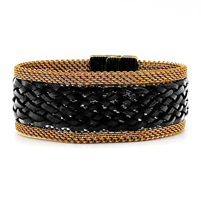 Narrow cuff bracelet with gold mesh edges and black braided leather, tilted to show the closed magnetic clasp, on a white background.