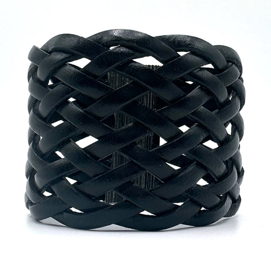 Wide cuff bracelet of braided black Italian leather, closed with a gunmetal magnetic clasp.
