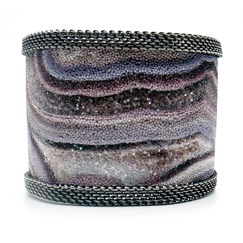 Wide cuff bracelet with oxidized silver mesh framing a multi-color Botswana agate slice pattern highlighted by shiny and matte Swarovski micro-crystals, on a white background.