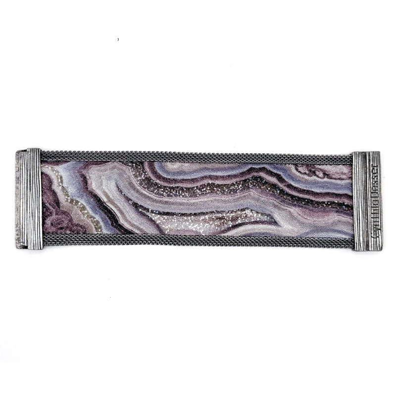 Wide cuff bracelet with oxidized silver mesh framing a multi-color Botswana agate slice pattern highlighted by shiny and matte Swarovski micro-crystals, laid open flat to show off the signature Cynthia Desser magnetic clasps, on a white background.