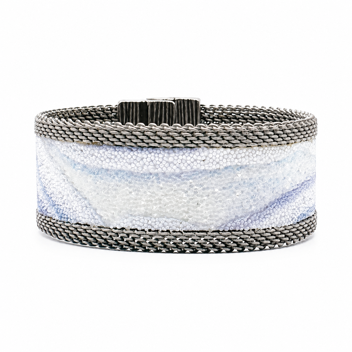 Narrow cuff bracelet with blue lace agate slice pattern highlighted by shiny and matte Swarovski micro-crystals, with matte silver mesh edges, on a white background.
